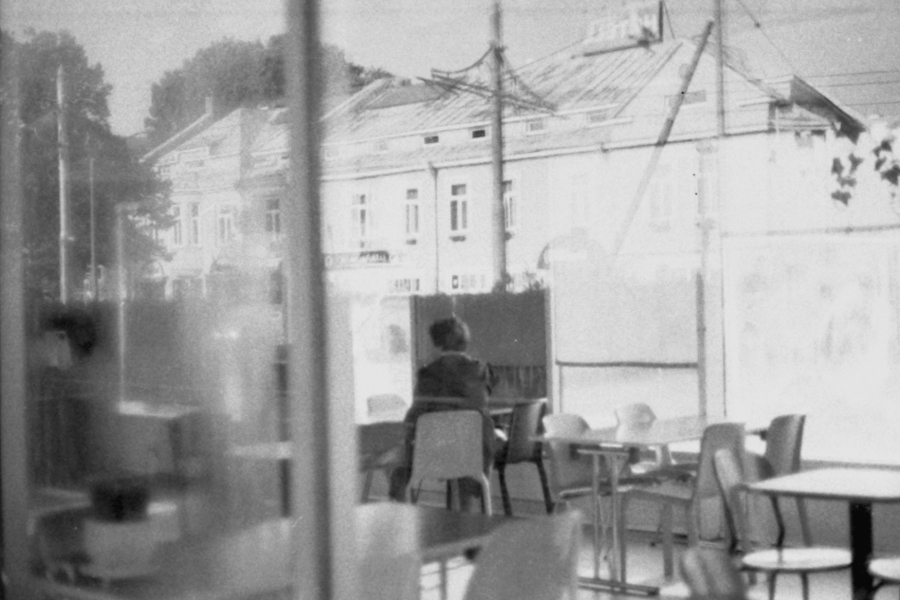 [A woman in an empty cafe]